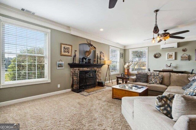 carpeted living room featuring a wall mounted air conditioner, a healthy amount of sunlight, and ceiling fan