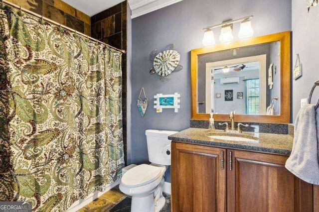 bathroom with a wall unit AC, ceiling fan, toilet, vanity, and curtained shower