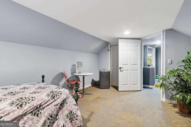 bedroom with lofted ceiling and light colored carpet