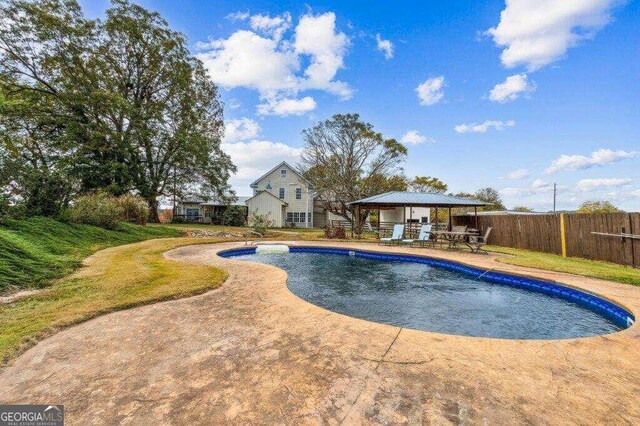 view of swimming pool with a gazebo and a patio area