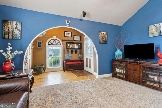 living room featuring vaulted ceiling and hardwood / wood-style floors