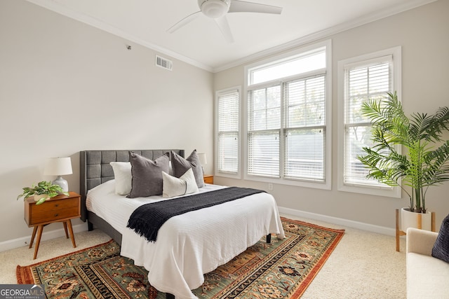 bedroom featuring ornamental molding, carpet, and ceiling fan