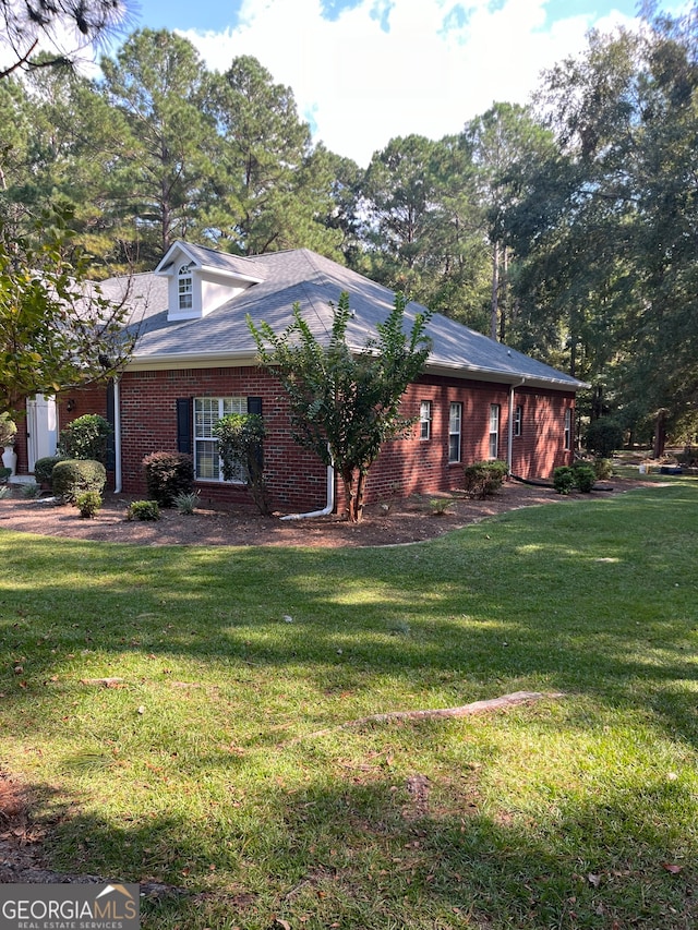 view of property exterior with a lawn