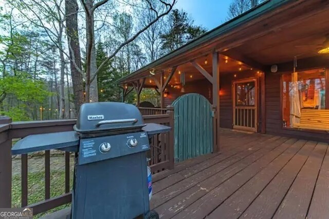 wooden terrace featuring grilling area