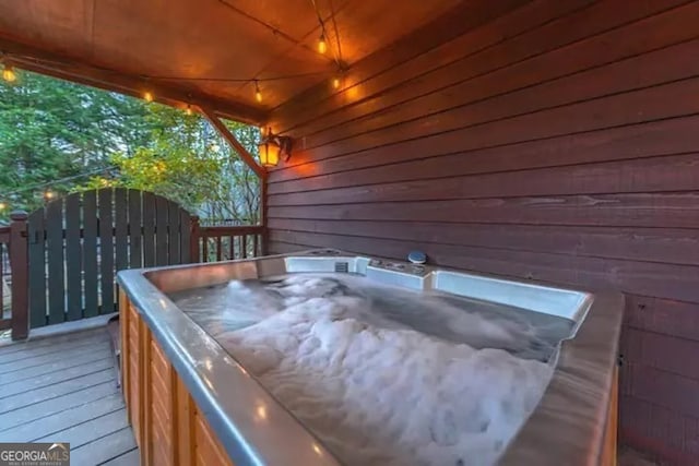 wooden deck featuring a hot tub