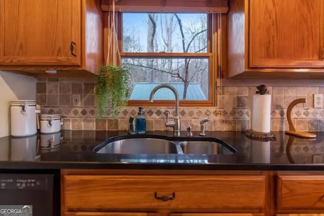 kitchen featuring decorative backsplash, sink, and dishwasher