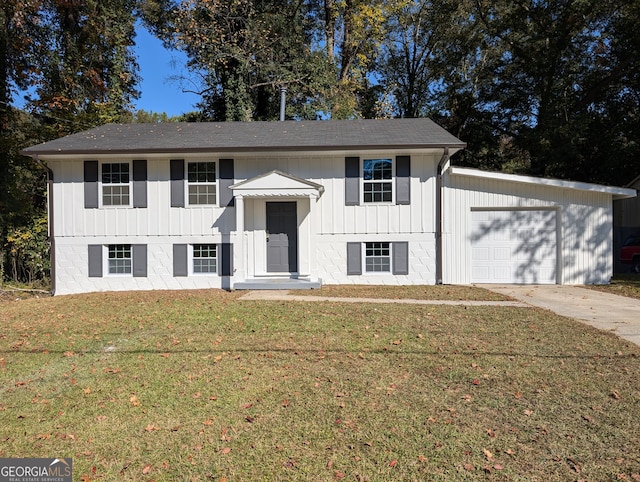 bi-level home featuring a front yard and a garage