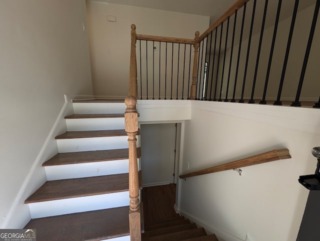 stairs featuring hardwood / wood-style floors