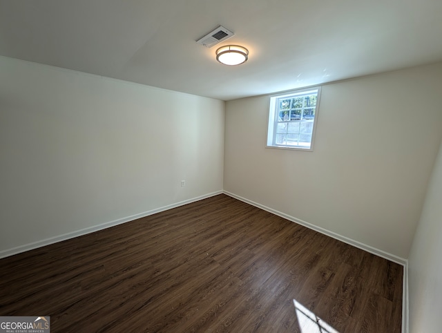 spare room with dark wood-type flooring