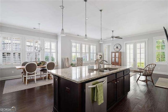 kitchen with a center island with sink, dishwasher, ornamental molding, dark wood-type flooring, and decorative light fixtures