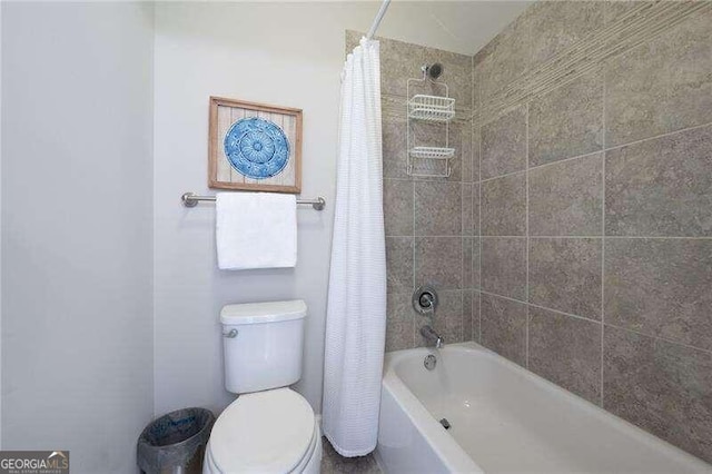 bathroom featuring toilet and shower / bath combo with shower curtain