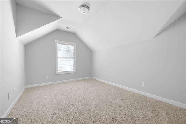 bonus room featuring vaulted ceiling and carpet floors