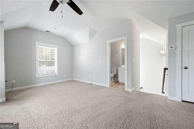 bonus room featuring vaulted ceiling, light colored carpet, and ceiling fan