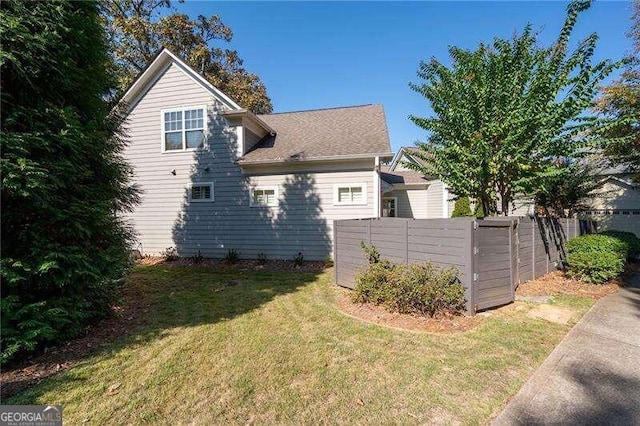 view of side of home with a lawn