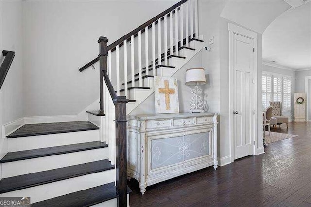 staircase featuring crown molding and wood-type flooring