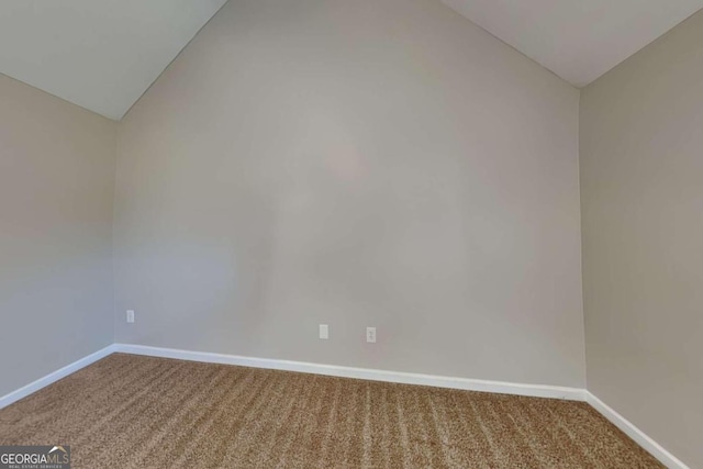 unfurnished room with carpet flooring and lofted ceiling