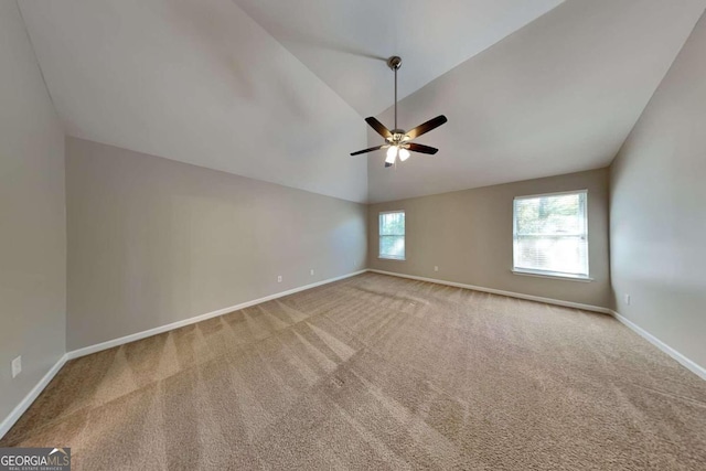 empty room with ceiling fan, high vaulted ceiling, and carpet flooring