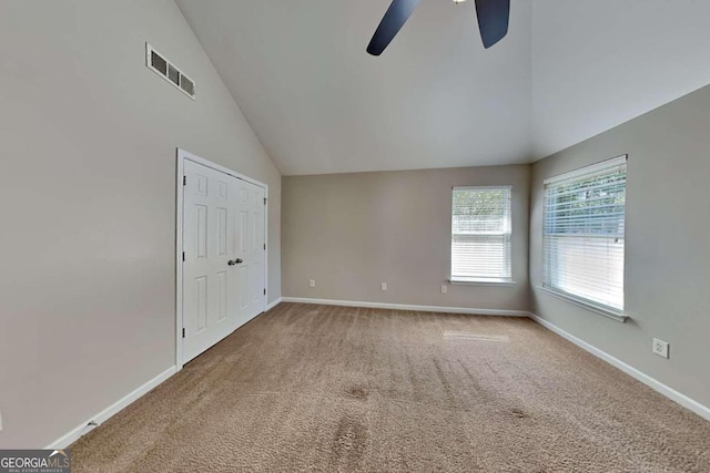 spare room with lofted ceiling, carpet flooring, and ceiling fan