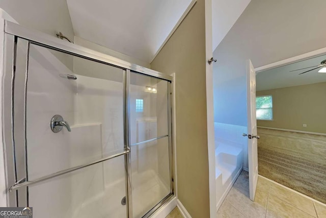 bathroom with lofted ceiling, ceiling fan, a shower with shower door, and tile patterned flooring