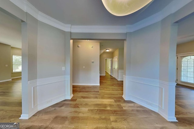 hall featuring crown molding and light hardwood / wood-style floors