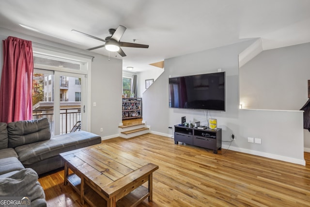 living room with ceiling fan and light hardwood / wood-style flooring