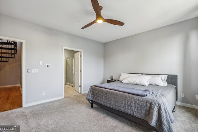 carpeted bedroom with ceiling fan and ensuite bathroom