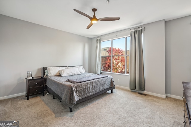 bedroom with ceiling fan and light carpet