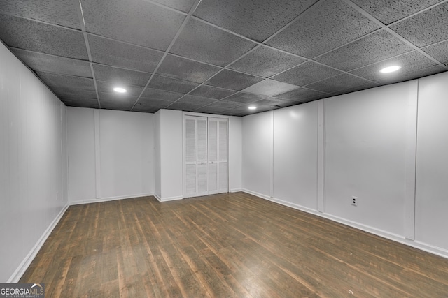 unfurnished room featuring a drop ceiling and dark wood-type flooring