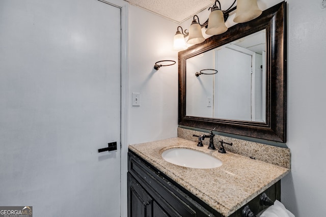 bathroom with vanity and a textured ceiling