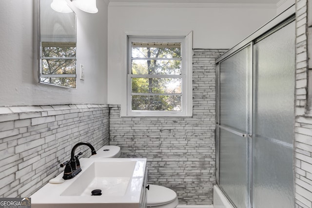 bathroom featuring vanity, toilet, ornamental molding, and tile walls