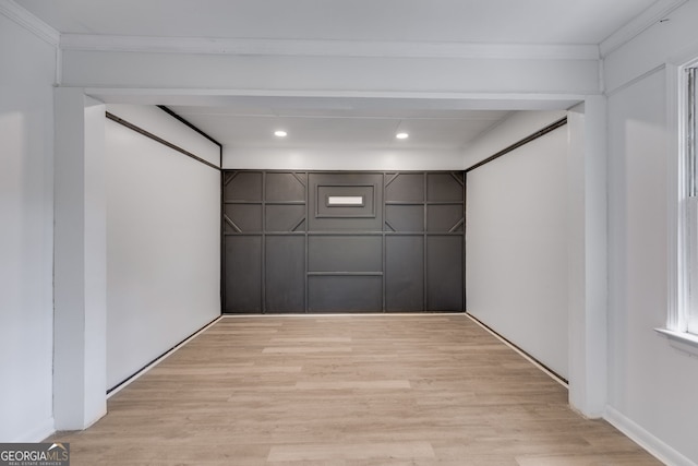 interior space featuring crown molding and light wood-type flooring