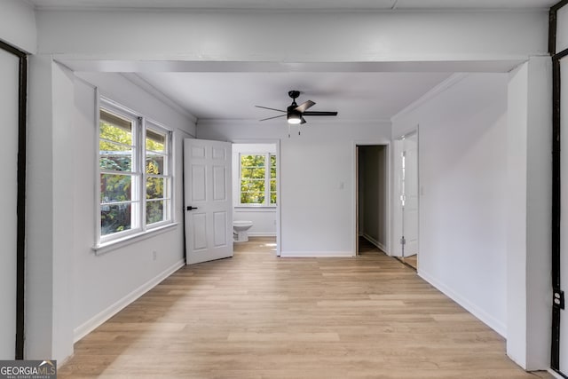 spare room with light hardwood / wood-style floors, ornamental molding, and ceiling fan