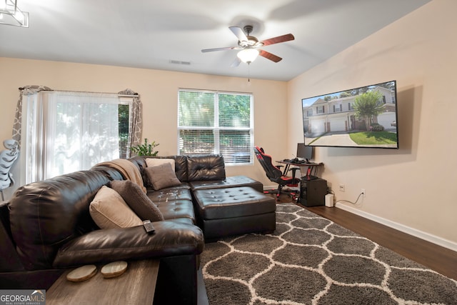 living room featuring dark hardwood / wood-style flooring and ceiling fan