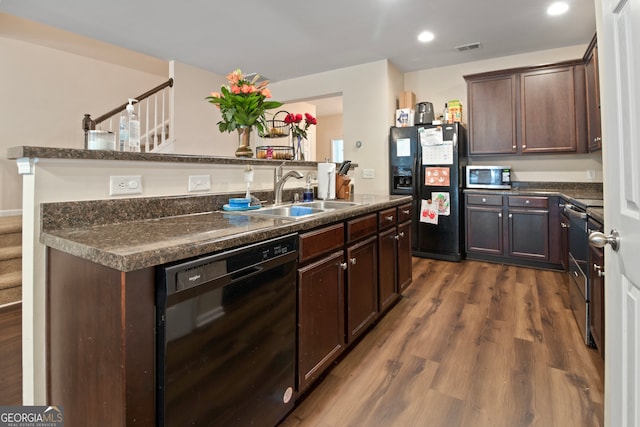 kitchen featuring dark brown cabinets, dark hardwood / wood-style flooring, black appliances, and sink