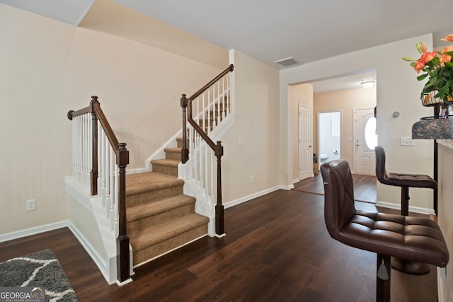 staircase with hardwood / wood-style flooring