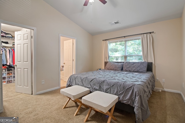 bedroom with carpet, vaulted ceiling, ceiling fan, and ensuite bath