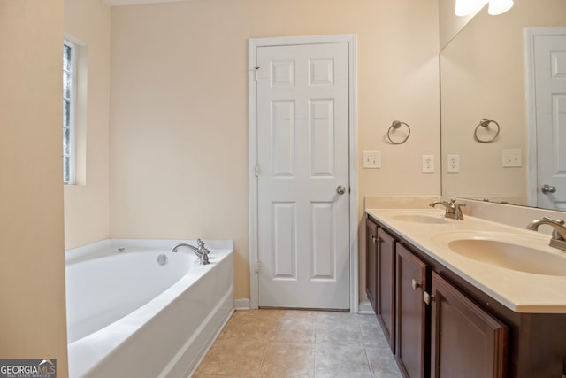 bathroom with vanity, tile patterned floors, and a washtub