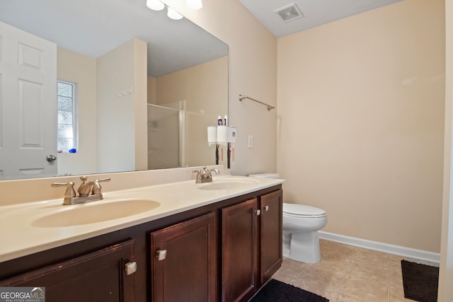 bathroom with vanity, walk in shower, tile patterned floors, and toilet