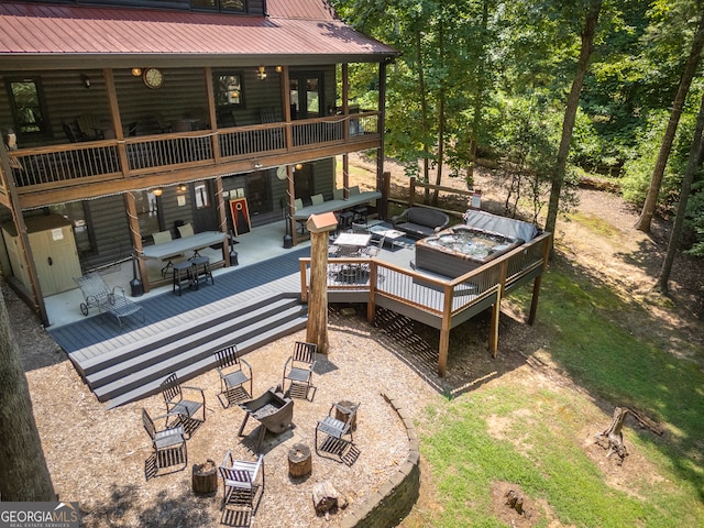 exterior space featuring a patio area and an outdoor living space with a fire pit