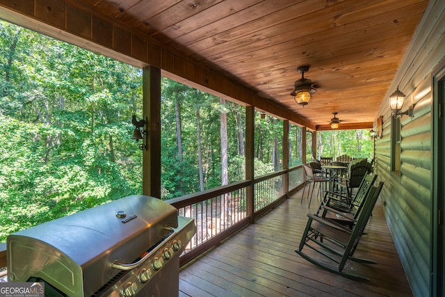 wooden terrace featuring a grill and ceiling fan