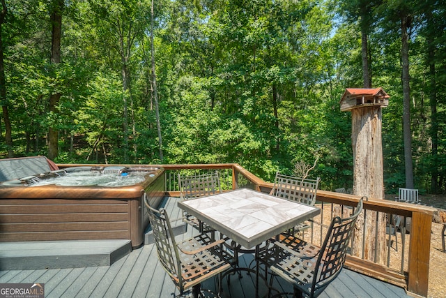 wooden terrace featuring a hot tub