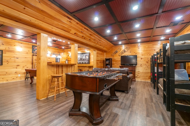 playroom with wooden walls, wood ceiling, and dark hardwood / wood-style flooring