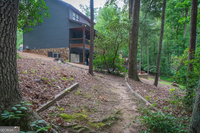 view of yard featuring cooling unit and a balcony