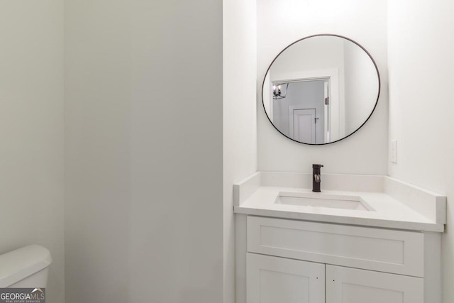 bathroom featuring toilet and vanity