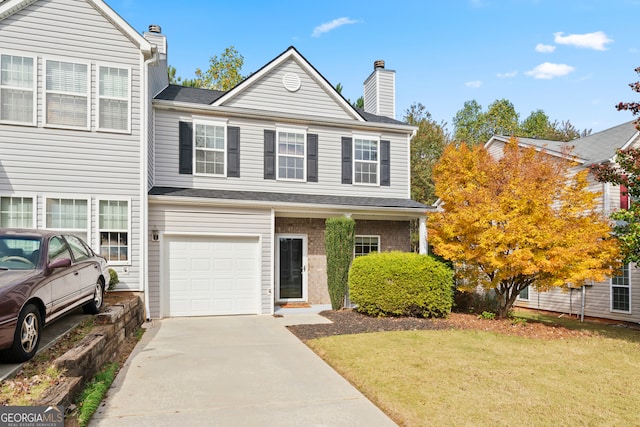 view of property with a front yard and a garage