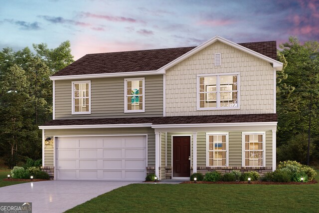 view of front facade featuring a yard and a garage