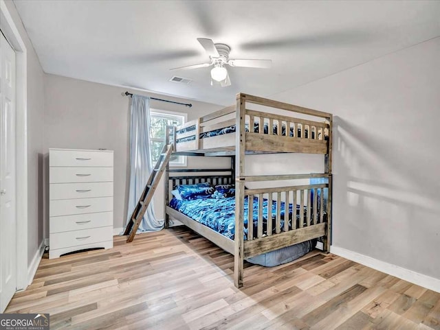 bedroom with light hardwood / wood-style floors and ceiling fan