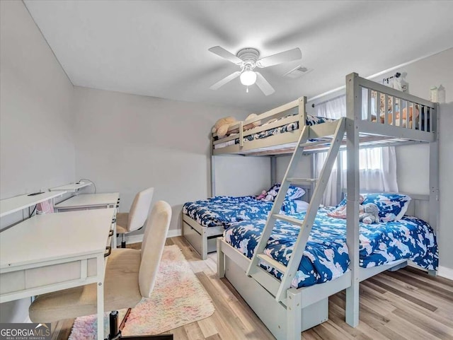 bedroom with light hardwood / wood-style floors and ceiling fan