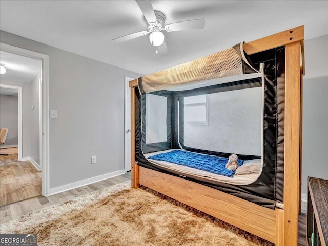 bedroom featuring ceiling fan and hardwood / wood-style floors