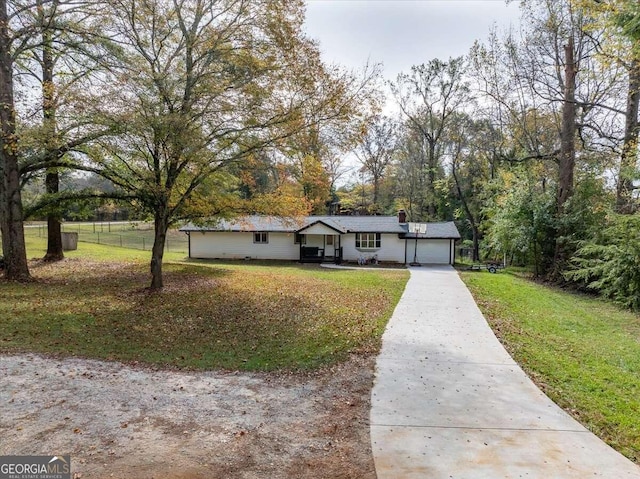 ranch-style house with covered porch, a front lawn, and a garage